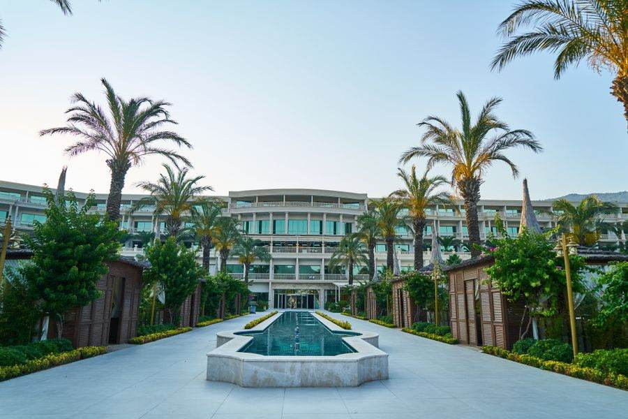 Palm-lined hotel courtyard with fountain
