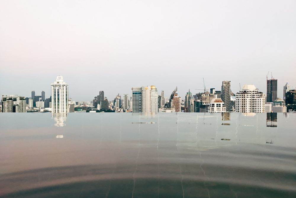 Infinity pool edge meeting a city skyline